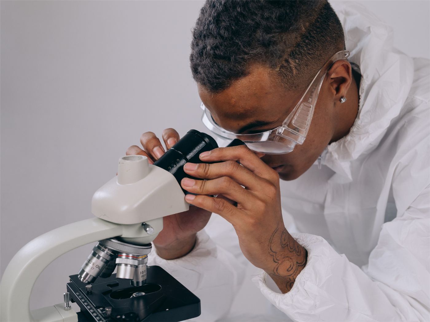 A scientist working at a microscope